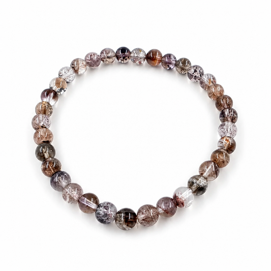 Close-up of gold rutile and red lepidocrocite threads inside black super seven beads