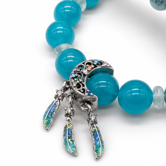 Close-up of turquoise-green Amazonite beads with pale cloud-like veining on white