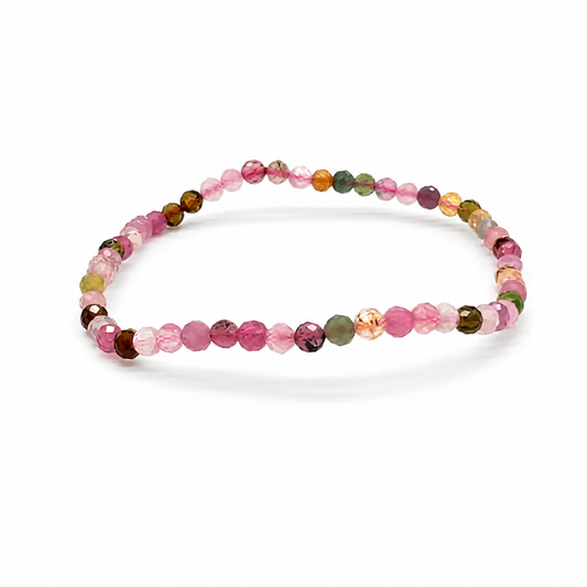 Close-up of faceted multi-coloured tourmaline beads catching light