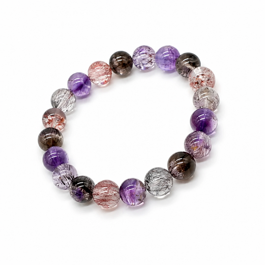 Close-up of transparent Super 7 beads showing amethyst and rutile inclusions