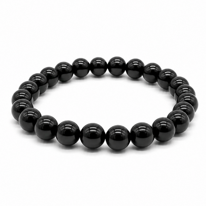 Handmade hypersthene crystal bracelet, deep black-grey beads with silvery sheen, on white background