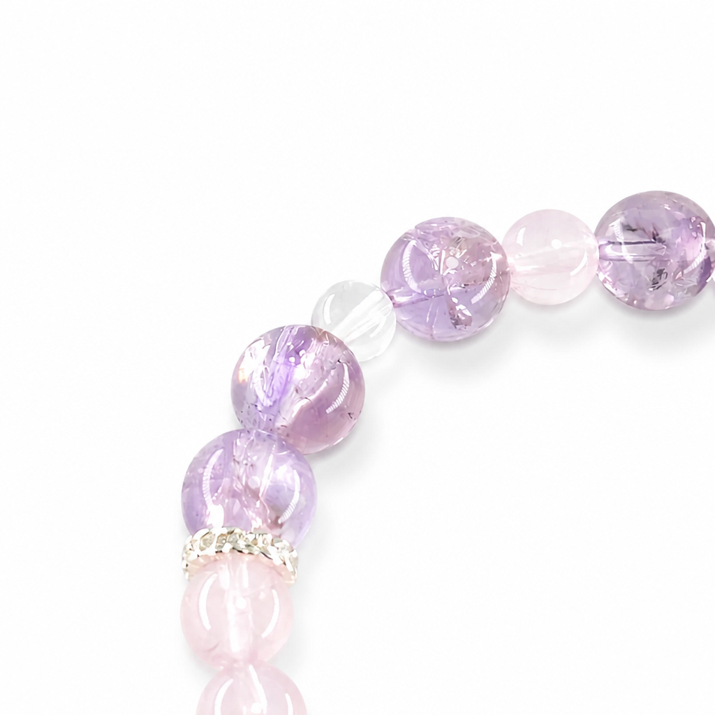 Silver-toned decorative beads beside Amethyst Pixiu carving