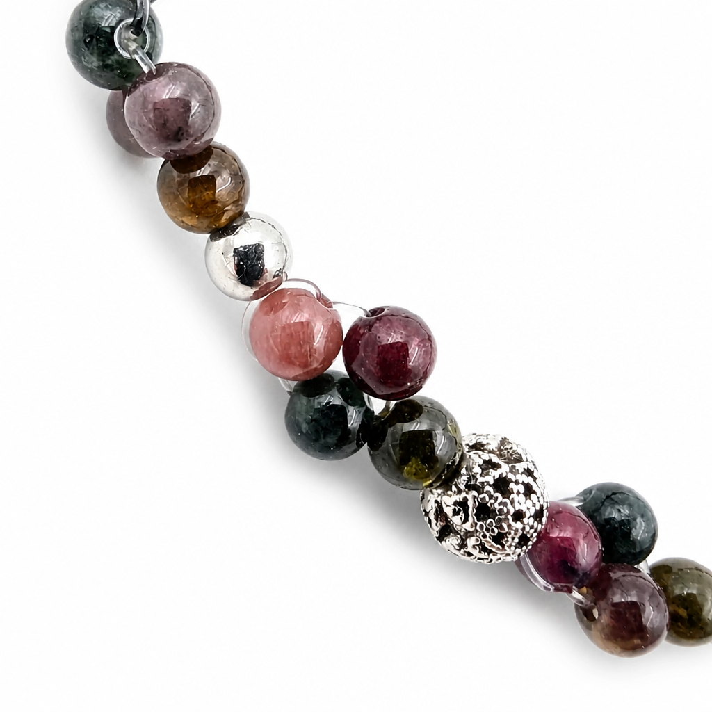 Detail of pink, plum and amber tourmaline beads showing natural internal inclusions