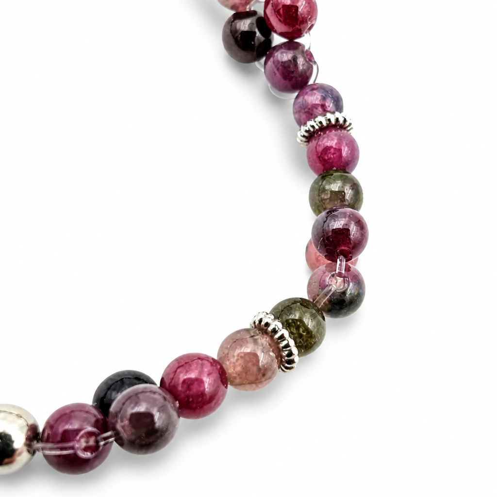 Angled detail of graded pink and green tourmaline beads on high-elastic wire
