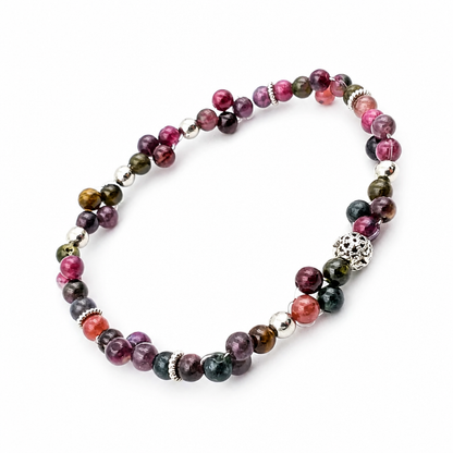 Complete multi-colour tourmaline bracelet arranged in a soft oval on a pale background