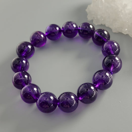 Purple beaded bracelet on a light gray background