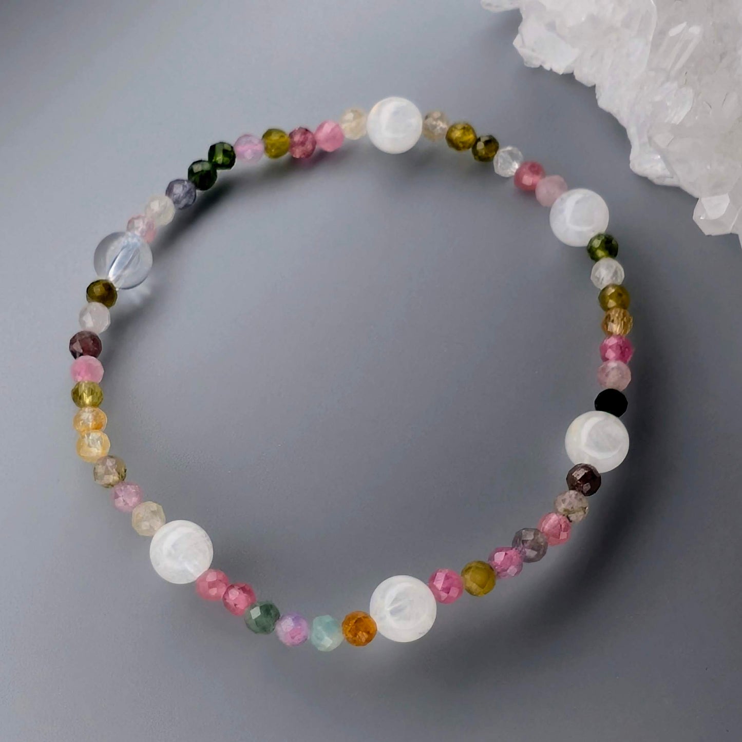 Multicolored beaded necklace on a gray surface