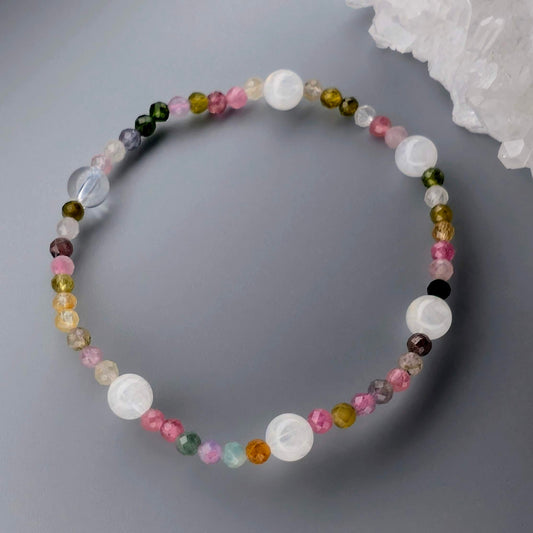 Multicolored beaded necklace on a gray surface
