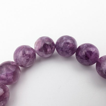 Detail of natural lepidolite showing lilac and soft grey banding