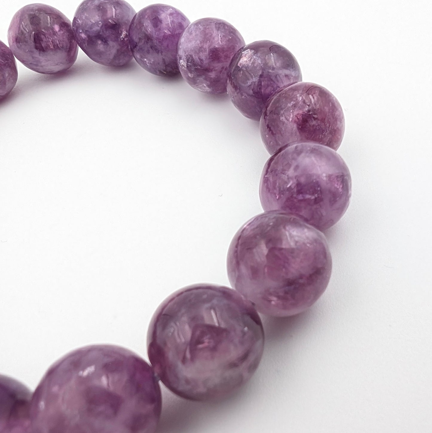 Round lepidolite beads with a soft silky lustre