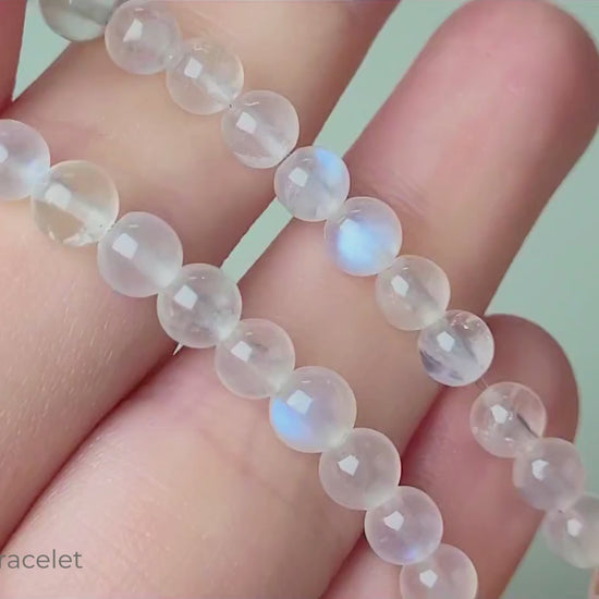 Sri Lanka Ceylon moonstone bracelet with translucent silvery-white round beads showing characteristic blue flash adularescence