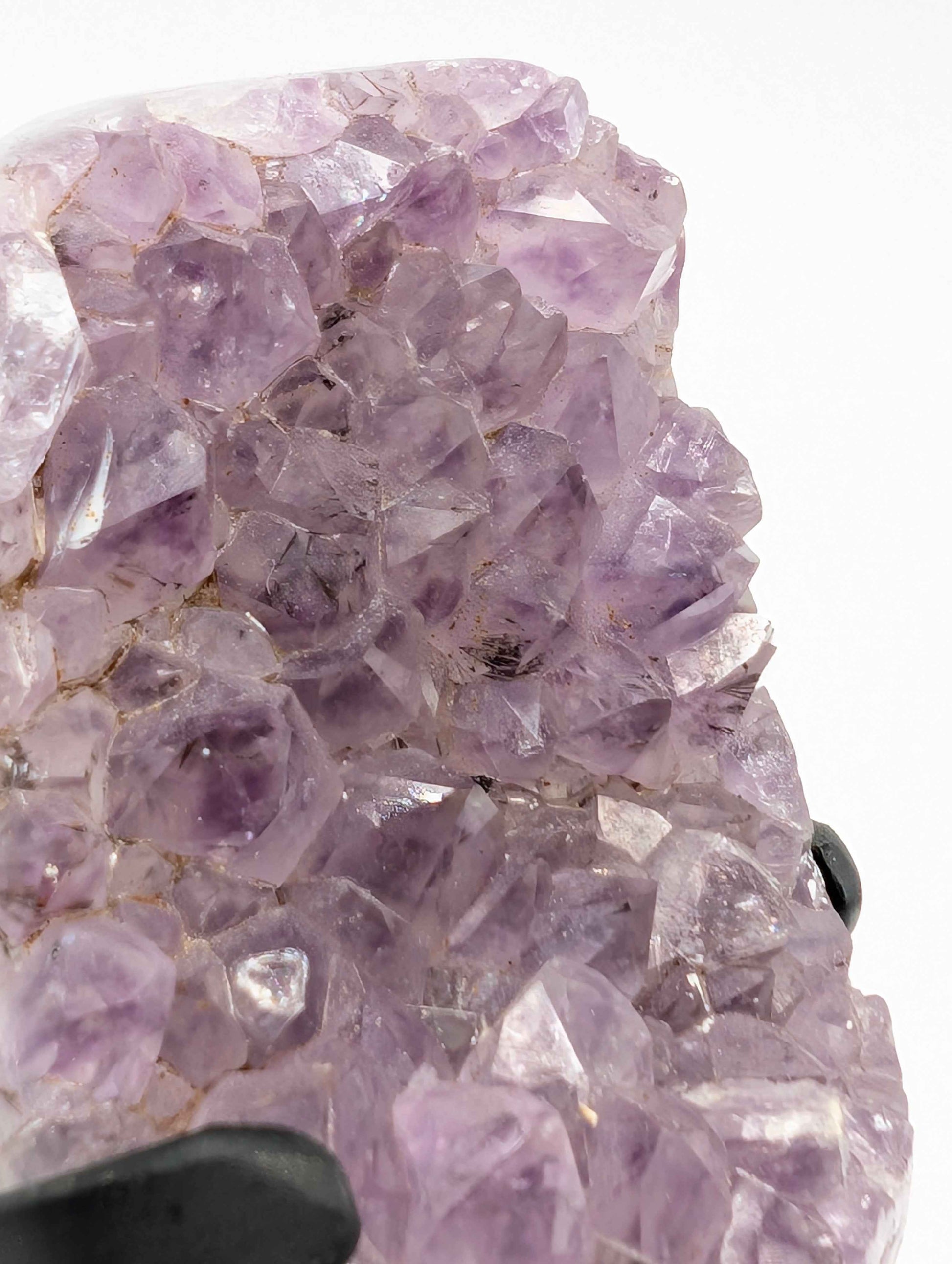 Side view of the lavender druzy amethyst spire showing full height on wooden stand