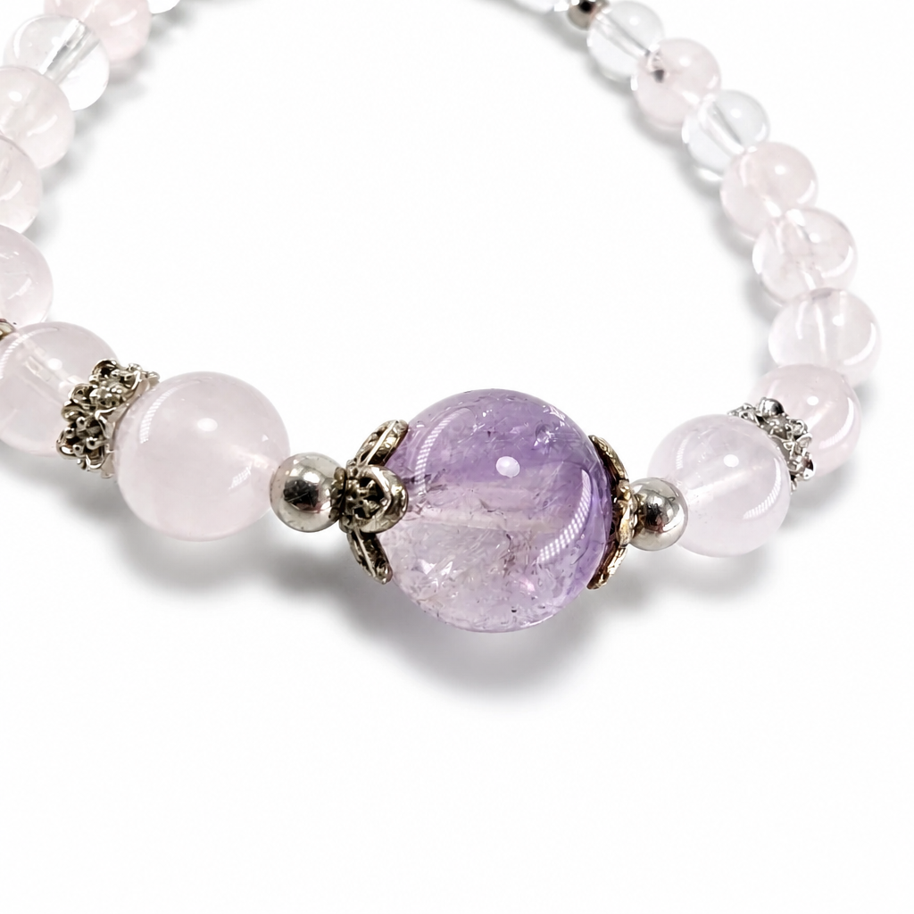 Silver butterfly filigree caps framing the Amethyst Super 7 focal bead on the bracelet