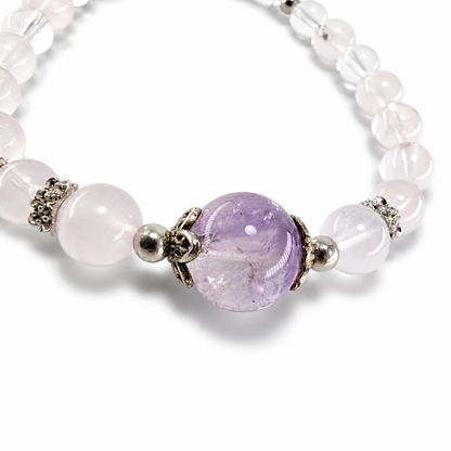Silver butterfly filigree caps framing the Amethyst Super 7 focal bead on the bracelet