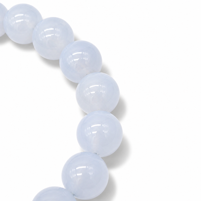 Side view of the Blue Chalcedony bracelet showing even colour and substantial bead weight on pale surface