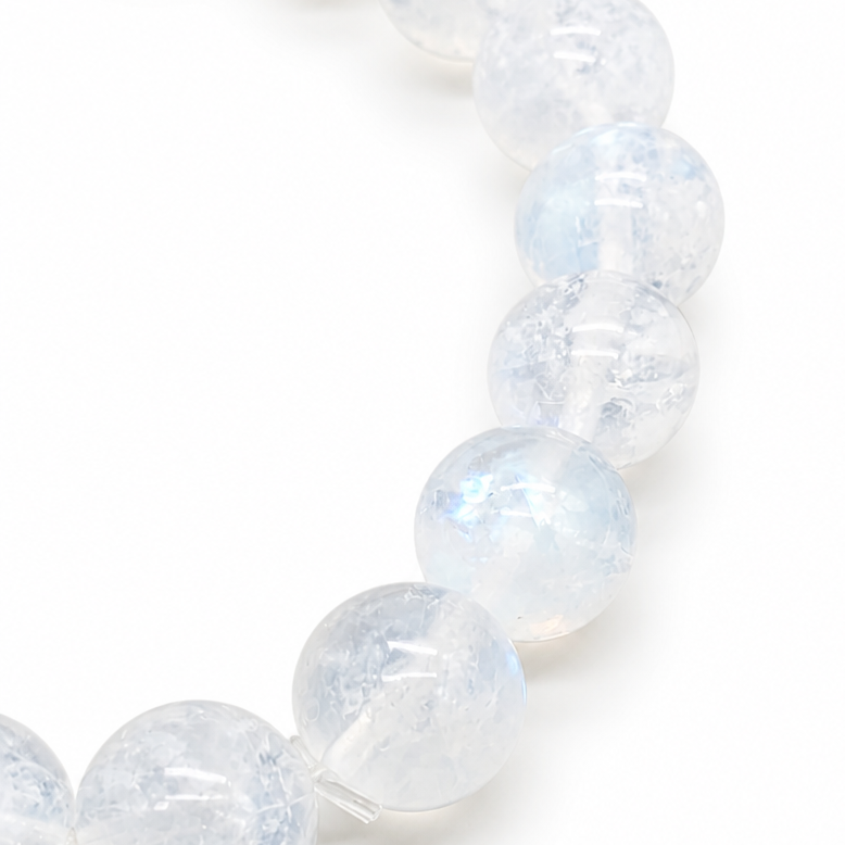 Close-up of diffuse milky sheen drifting across 9mm Indian Moonstone beads in natural light
