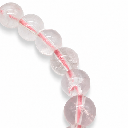 Angled view of the ice rose quartz bracelet catching light across each luminous 7.5mm bead
