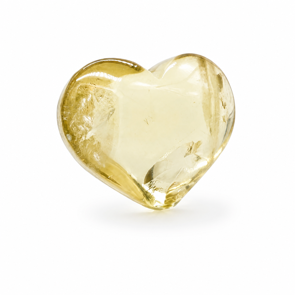 Solar rainbow citrine heart specimen with warm golden tones on a white surface