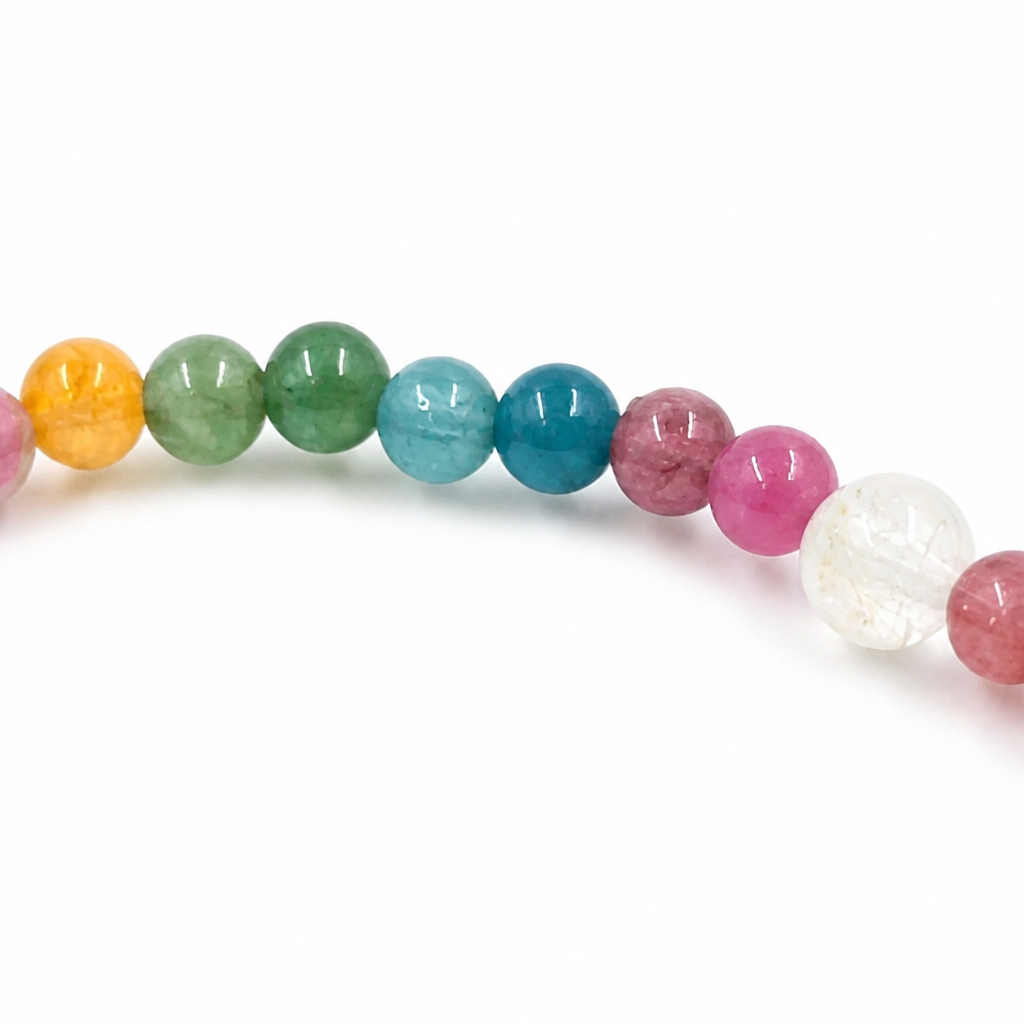 Angled view of the Pixiu Tourmaline Rainbow bracelet on a pale surface