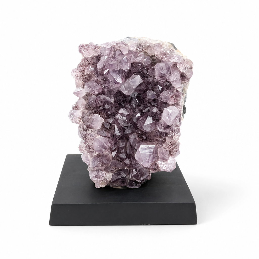 Full front view of the Phantom Amethyst spire on a dark wooden display base