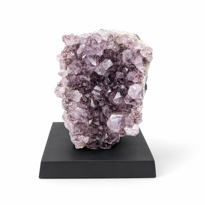 Full front view of the Phantom Amethyst spire on a dark wooden display base
