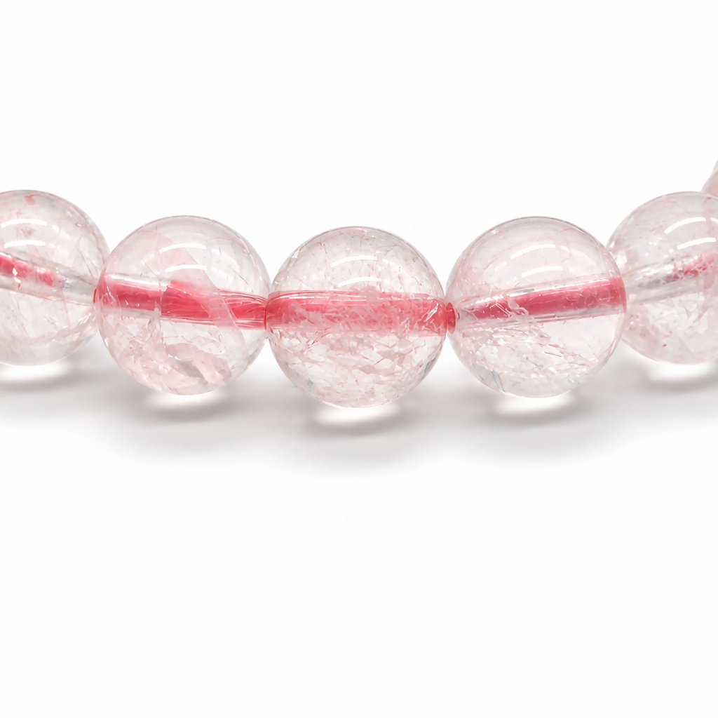 Light passing through near-transparent ice-grade rose quartz beads revealing soft pink depth