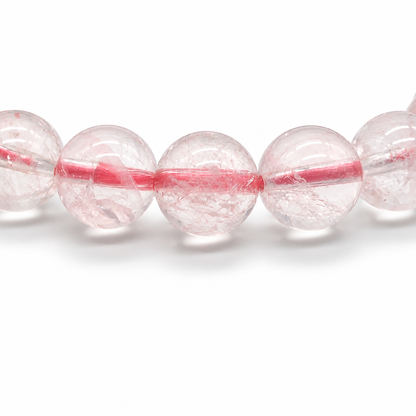 Light passing through near-transparent ice-grade rose quartz beads revealing soft pink depth