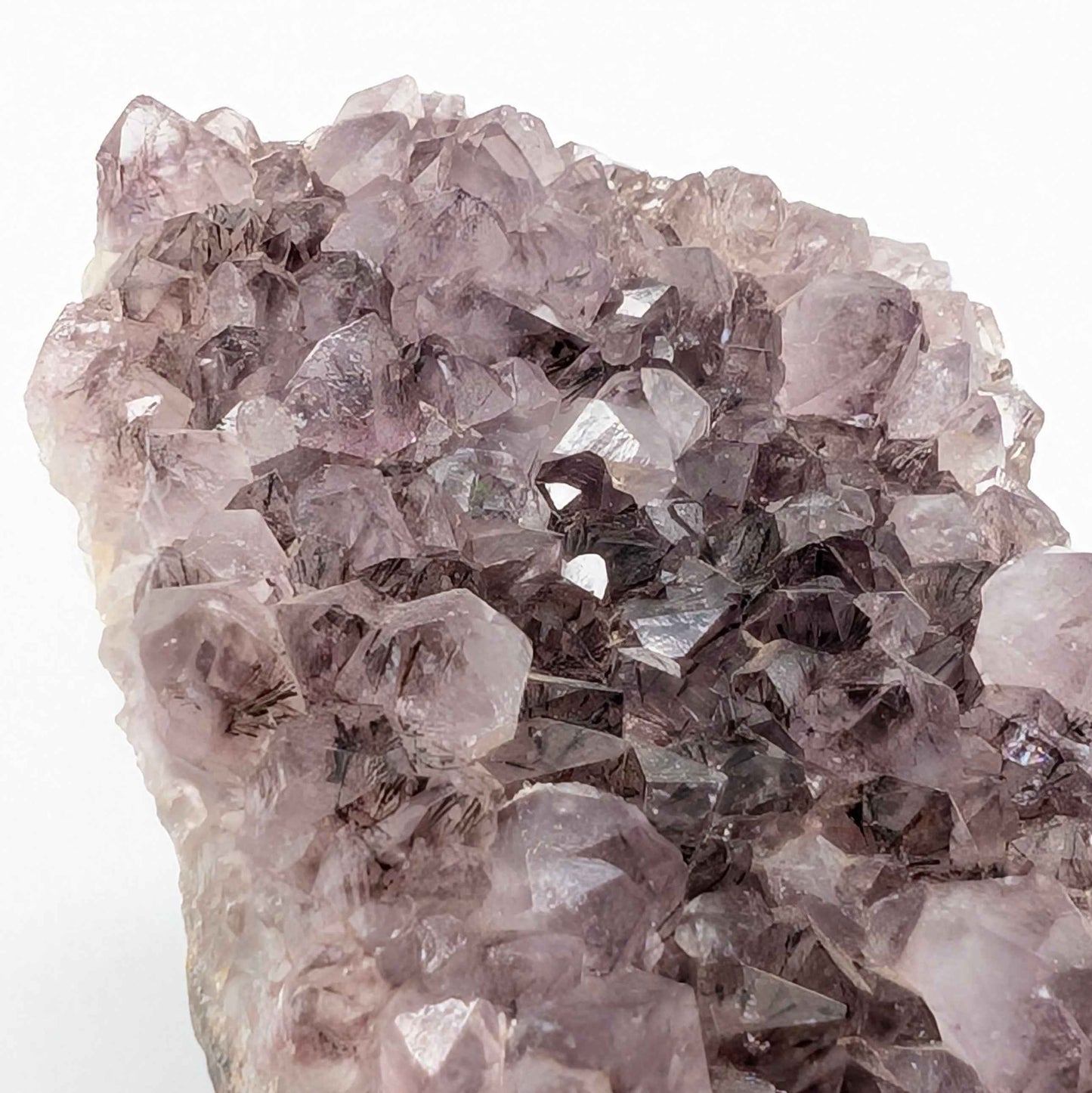 Side view of the Brazilian Amethyst spire showing full height on wooden base