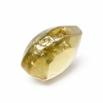 Close-up of prismatic rainbow inclusions inside a honey-gold citrine heart