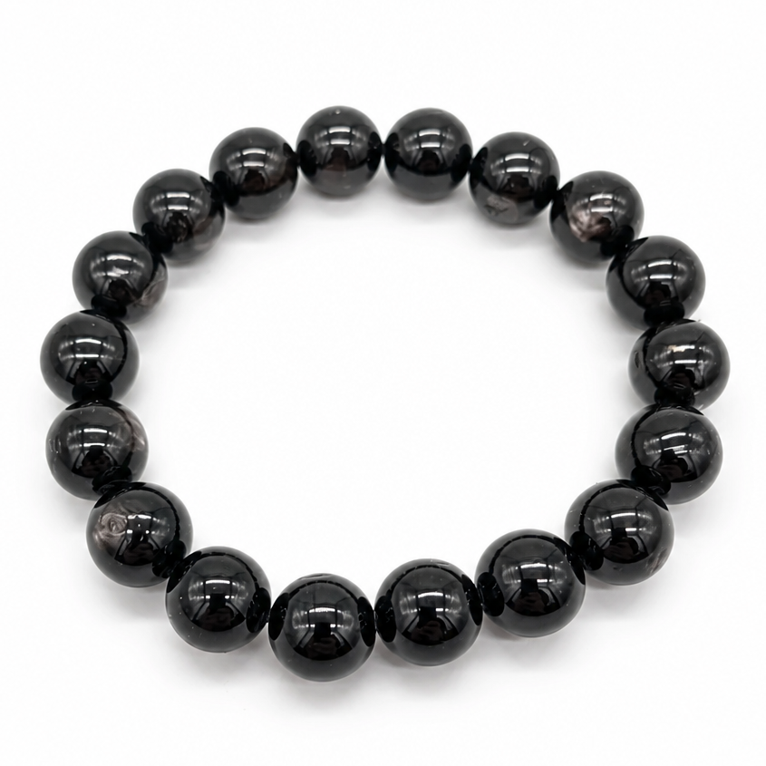 Hypersthene Schiller bracelet with large 11.5mm black beads and bronze-gold flash on white