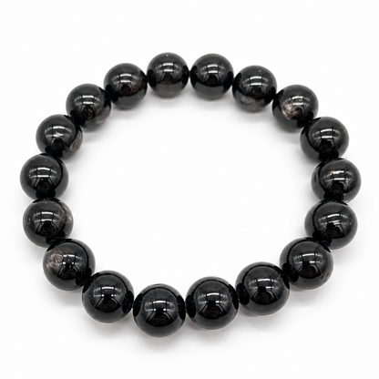 Hypersthene Schiller bracelet with large 11.5mm black beads and bronze-gold flash on white