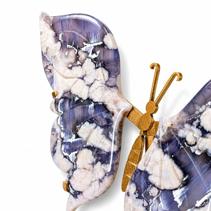 Gold butterfly stand holding the natural indigo agate specimen