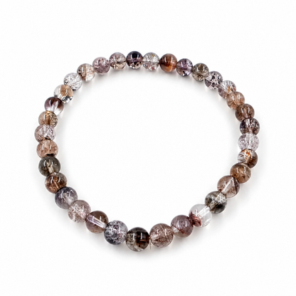 Close-up of gold rutile and red lepidocrocite threads inside black super seven beads