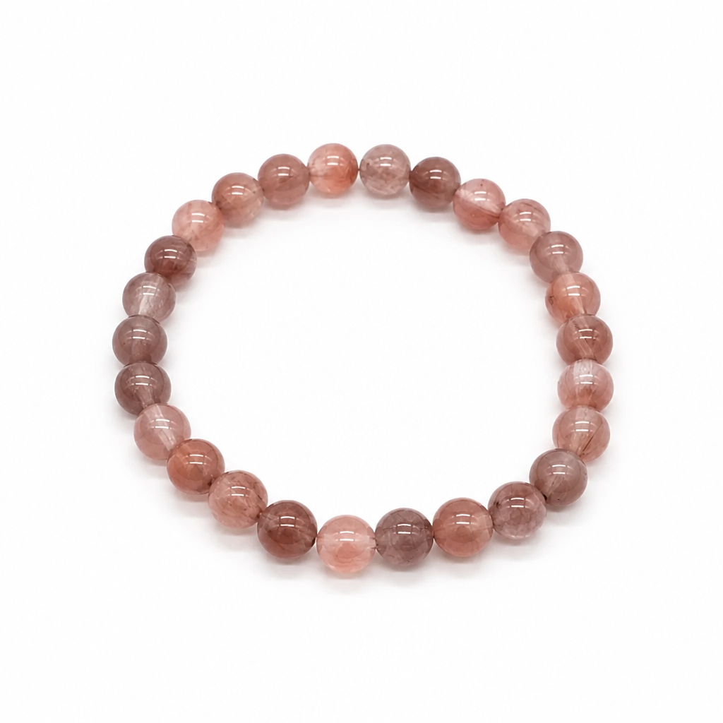 Close-up of clear quartz beads with red and pink hematite fibres