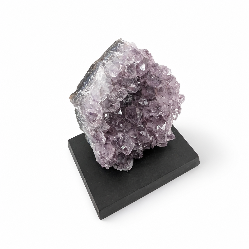 Black Goethite inclusions at the base of a natural amethyst crystal spire