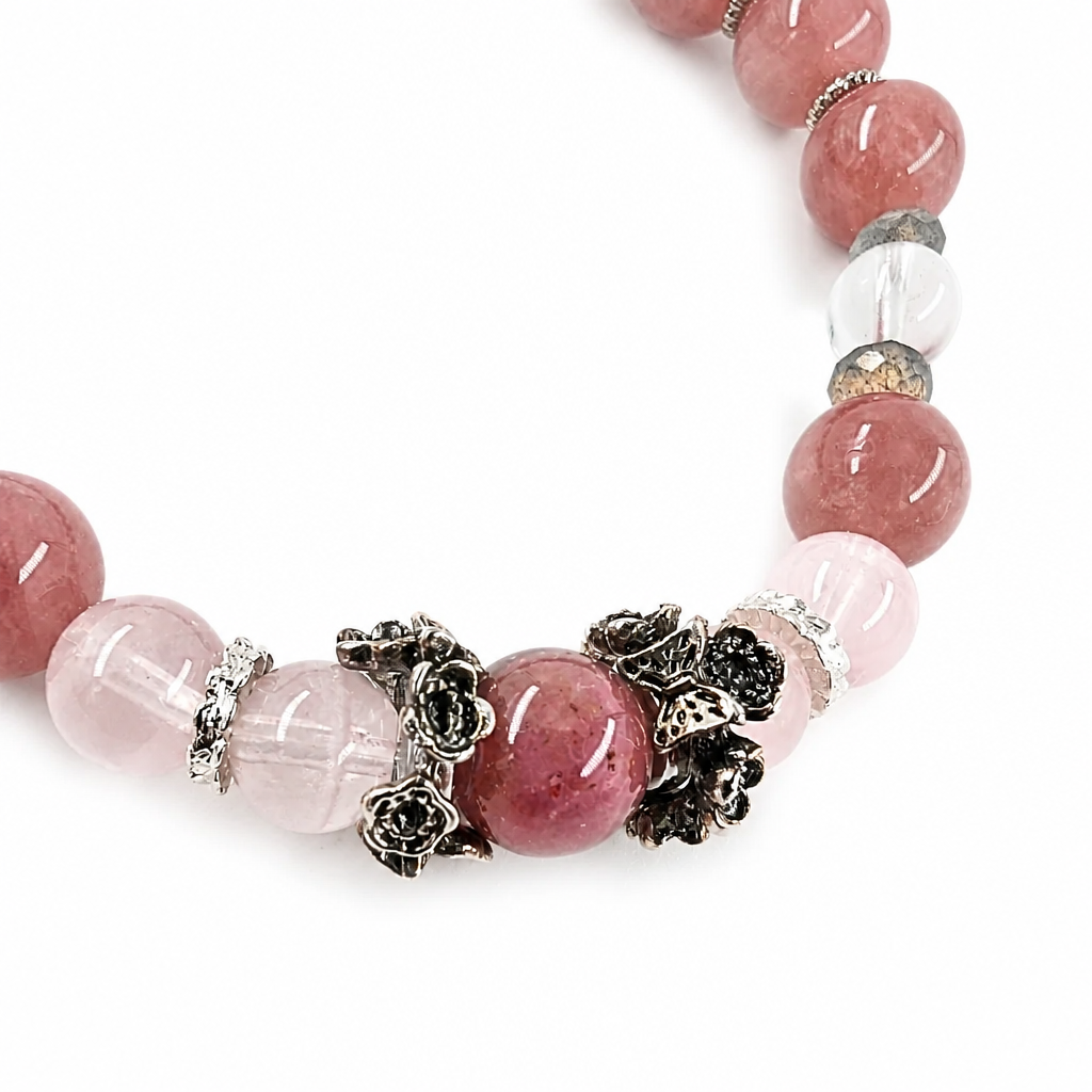 Labradorite bead showing blue flash beside rose quartz