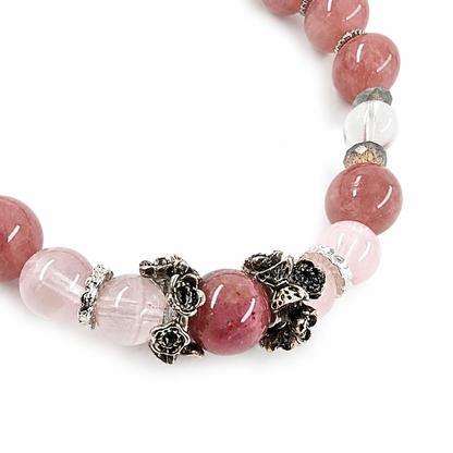 Labradorite bead showing blue flash beside rose quartz
