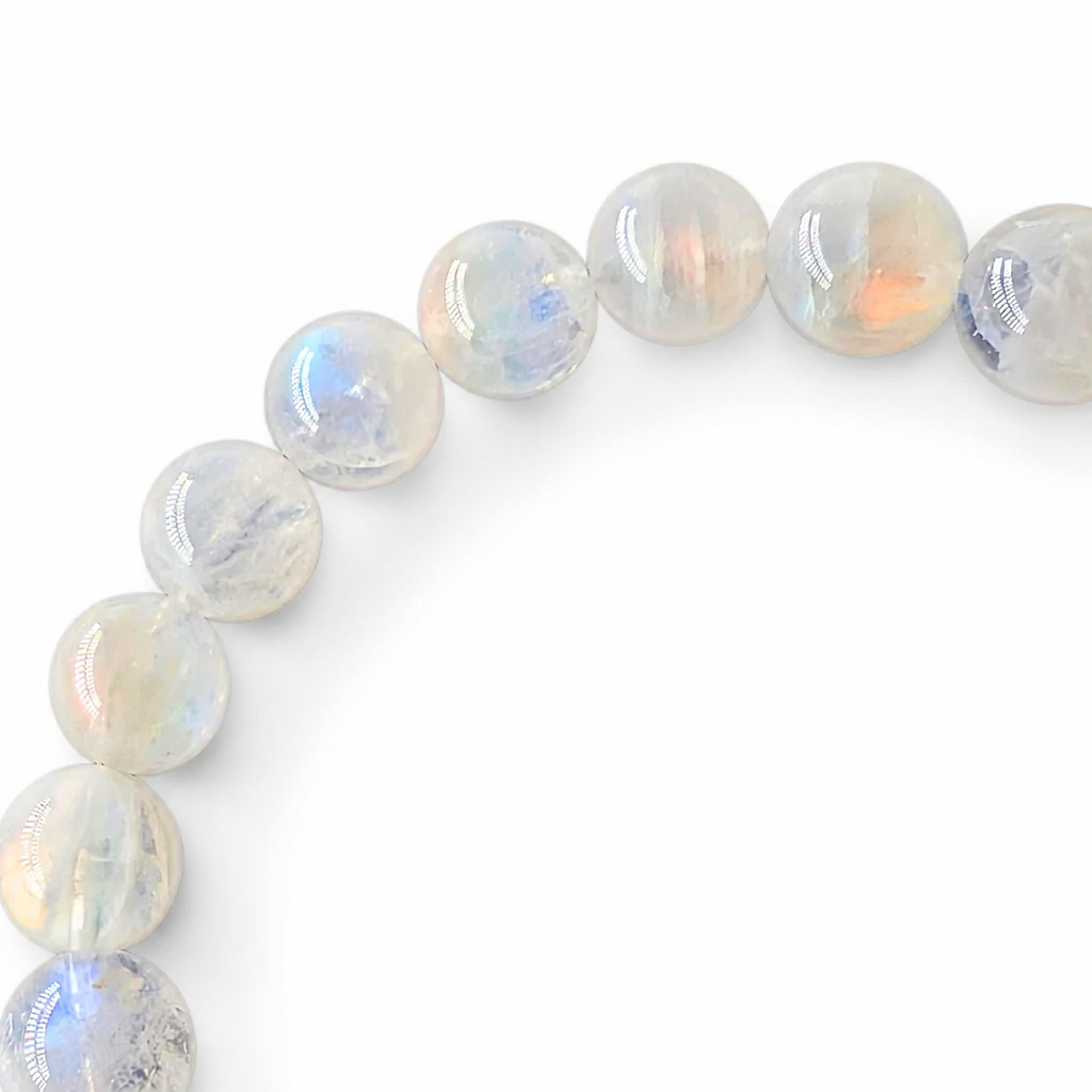 Side view of the Rosewater Moon bracelet showing 10mm bead presence on a pale surface