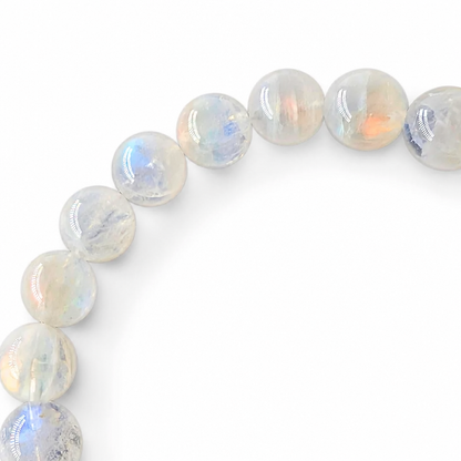 Side view of the Rosewater Moon bracelet showing 10mm bead presence on a pale surface