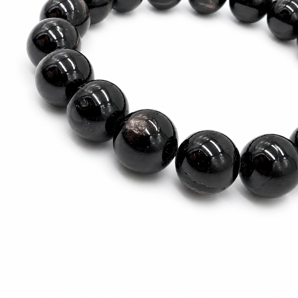 Hypersthene Schiller statement bracelet resting flat on a pale surface