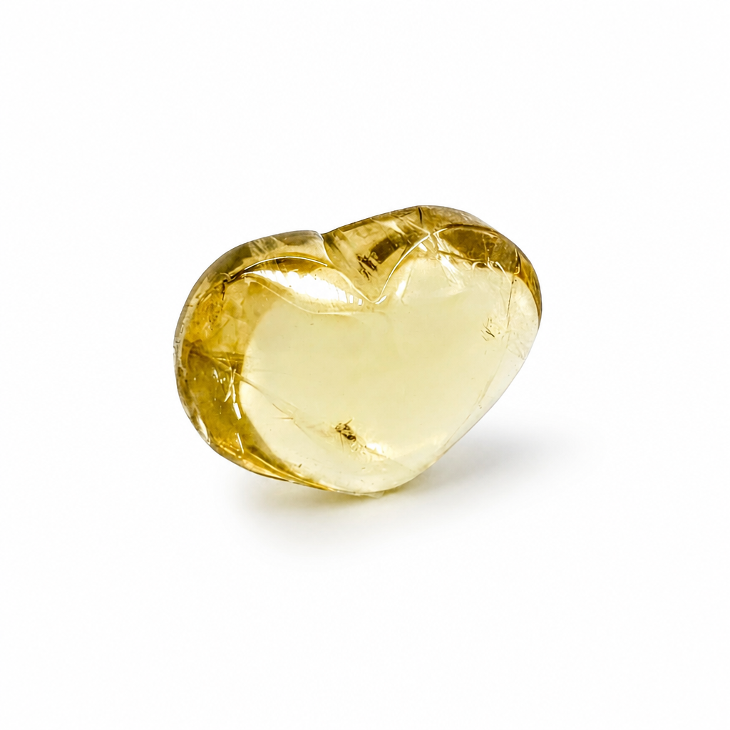 Side view of the natural citrine heart showing depth of honey-gold colour