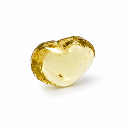 Side view of the natural citrine heart showing depth of honey-gold colour