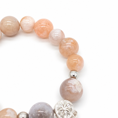 Detail of pink and red blossom formations in white agate