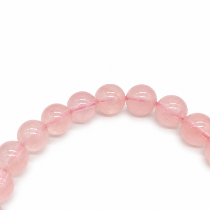 Warm pink rose quartz beads catching the light