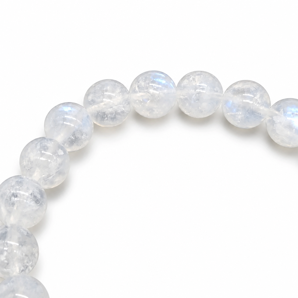 Side view of the 9mm Indian Moonstone bracelet showing substantial bead weight on a pale surface