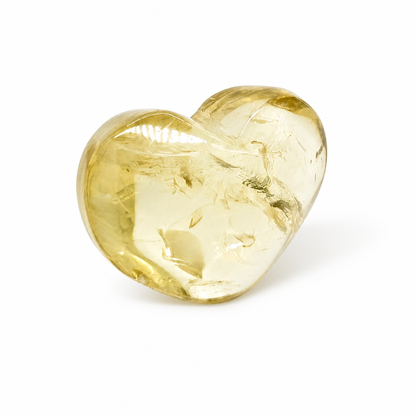 Close-up of rainbow veil inclusions inside a small honey-gold citrine heart