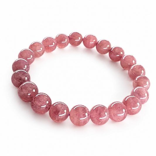Close-up of purple star rose quartz beads showing a six-rayed asterism star