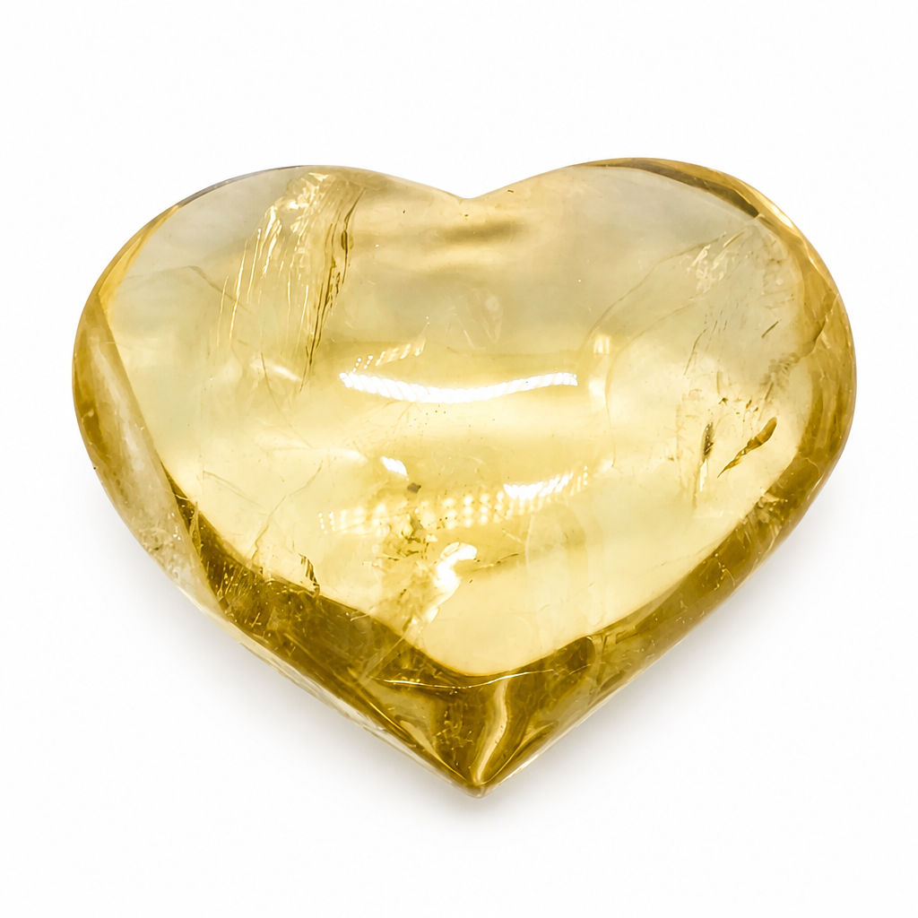 Aurora Citrine heart specimen with warm honey-gold tones on a white surface