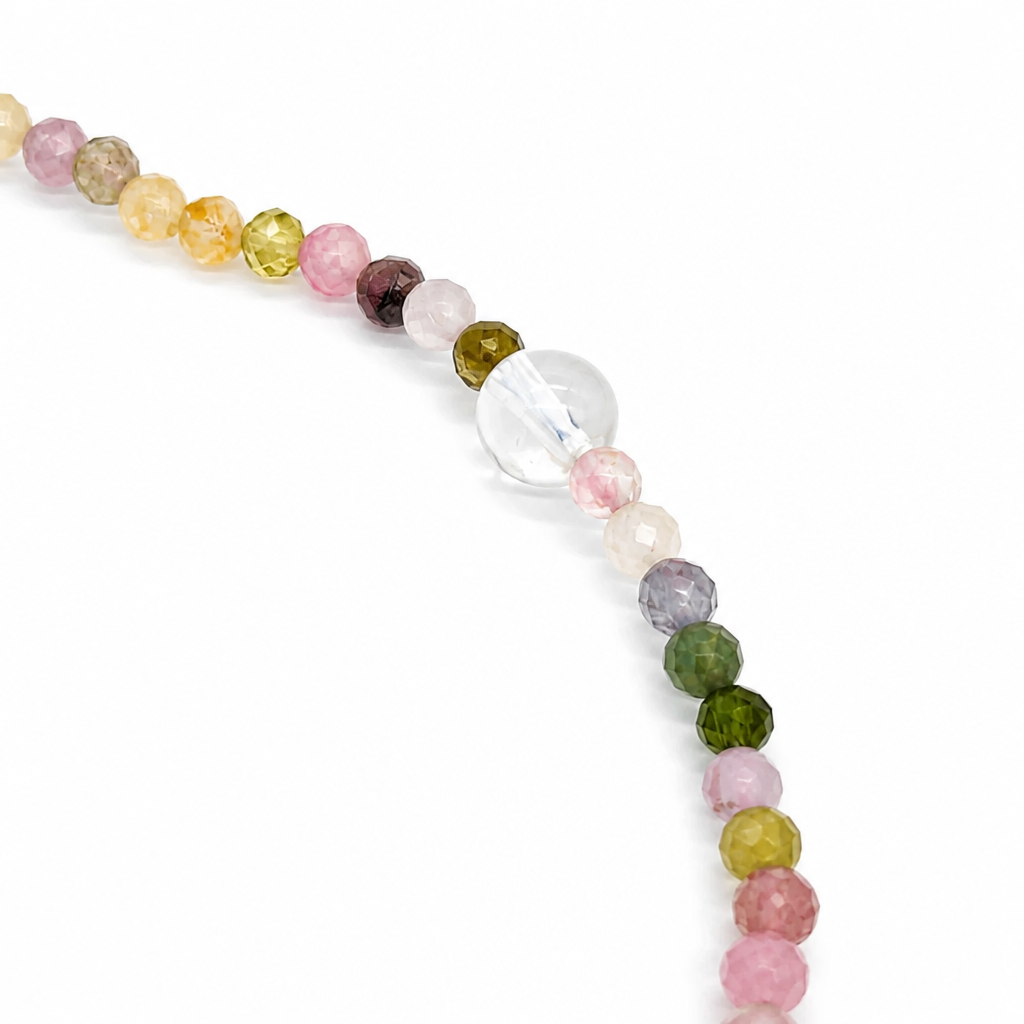 Rainbow tourmaline and moonstone designer bracelet curved on white