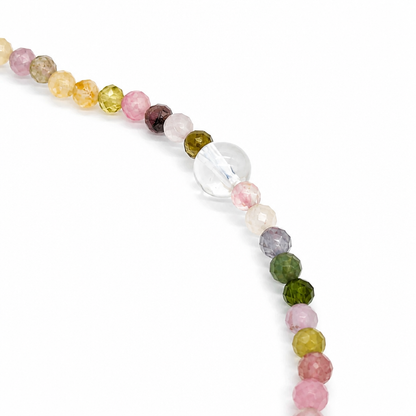 Rainbow tourmaline and moonstone designer bracelet curved on white
